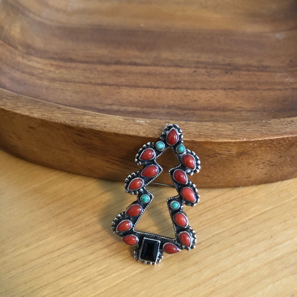 Coral, turquoise, and onyx brooch